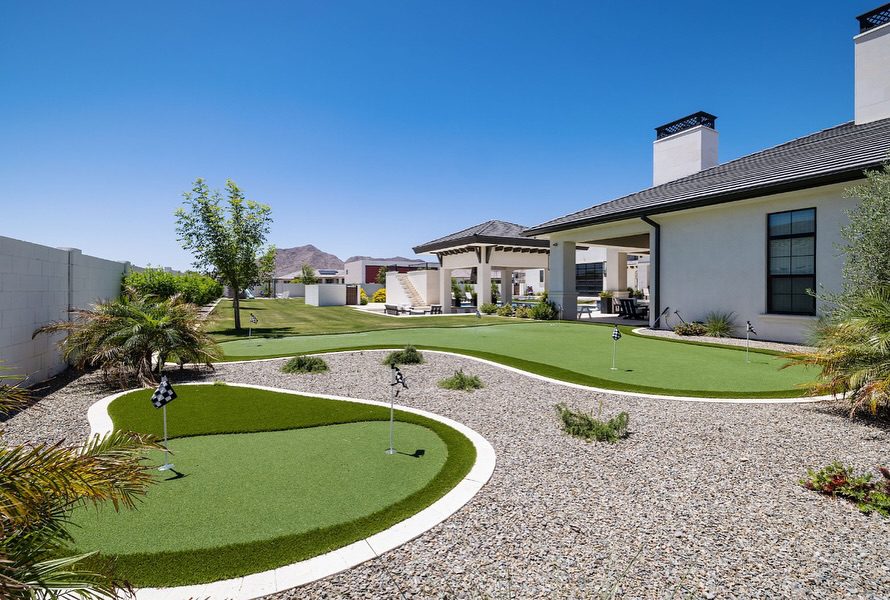 Gravel installation woven through a custom backyard putting green