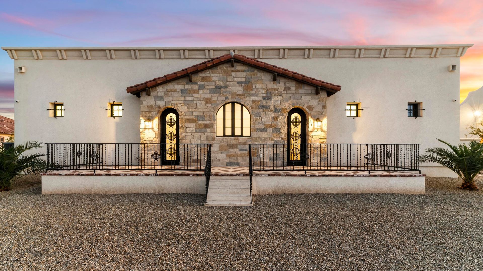 Mediterranean stone facade with balcony and wrought iron railings