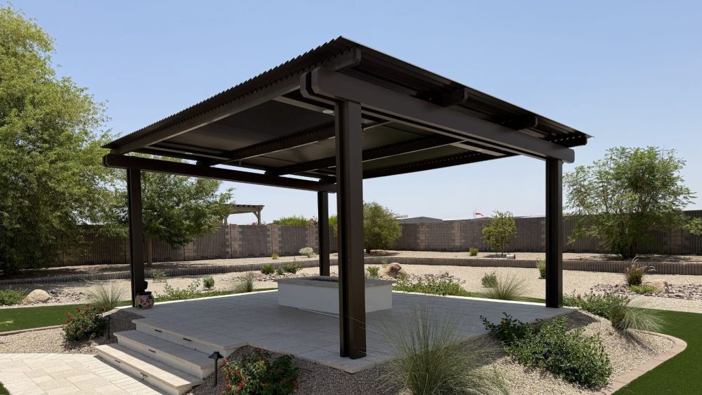Modern dark pergola over stone patio with fire pit