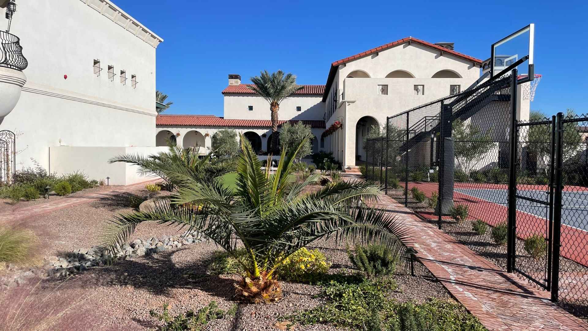 Granite stone mulch alongside a brick courtyard path