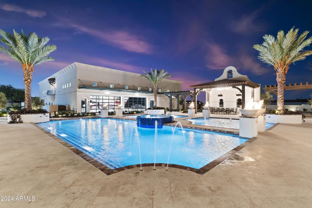 Grand outdoor living space with integrated spa and lighting